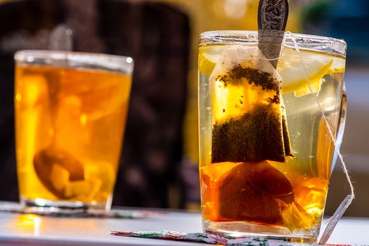 Transparent mug with tea. Brewing tea in a bag.