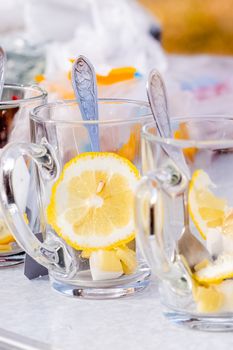 Transparent mug with tea. Brewing tea in a bag. Tea with lemon.