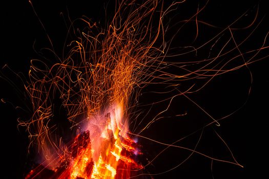 Sparks from a fire against a dark night. Bonfire