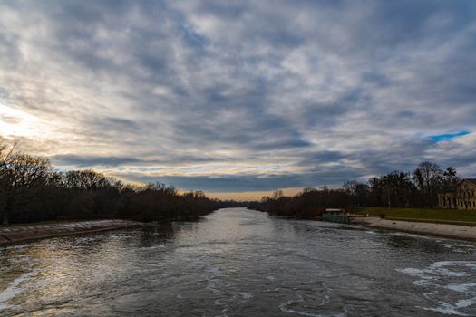 Cloudy landscape over Odra river near water dam with trees around