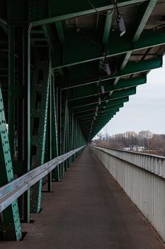 Long wooden and metal bridge with tram rails and green construction