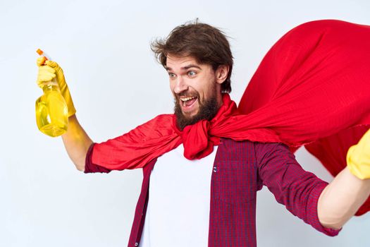 Cheerful male cleaner professional red raincoat housework lifestyle light background. High quality photo