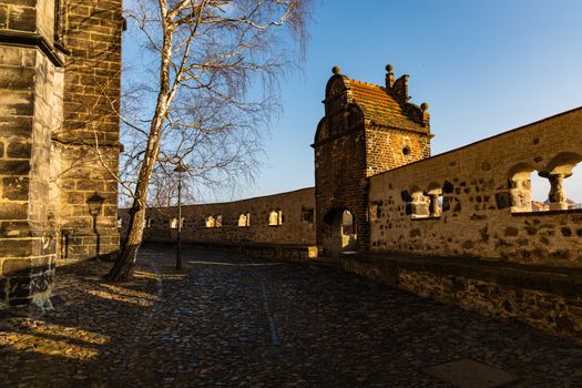 Small square behind old cathedral at sunny morning