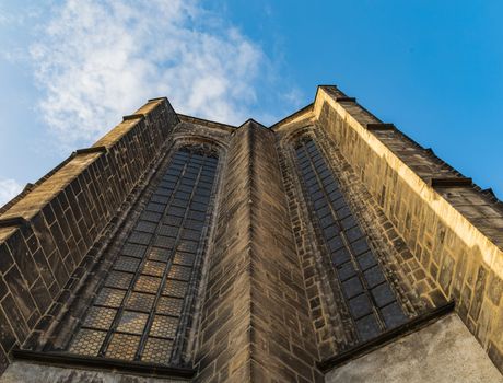 Upward view to wall of big cathedral with huge windows