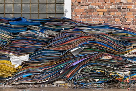 Stack of Old colorful plate tinwares near old building