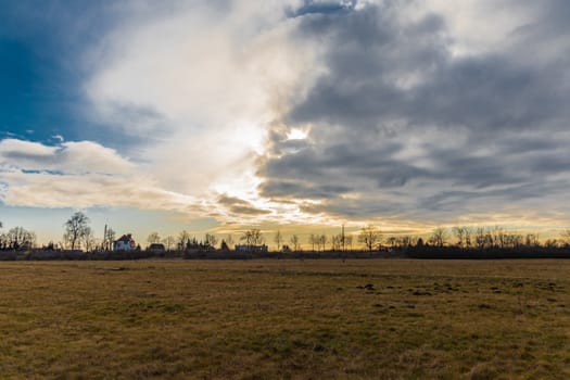 Cloudy sunset over large yellow fields