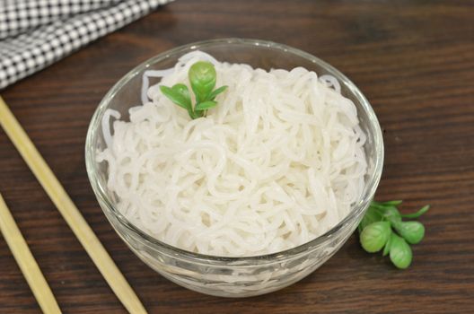 Konjac or Shirataki noodles with Chinese chopsticks. Japanese traditional dish. Healthy food for weight loss, keto diet concept.