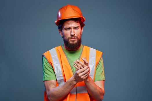 Man in working uniform to professionals construction lifestyle blue background. High quality photo