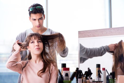 Man stylist working with woman in beauty salon