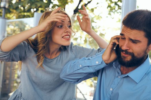 Man and woman outdoors work colleagues communicating phone teamwork. High quality photo