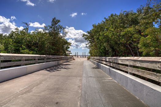 Boardwalk leading to Lovers Key State Park on a sunny day in Fort Myers, Florida