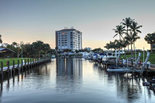 Cocohatchee River Park Marina boats lined up at sunset in Naples, Florida.