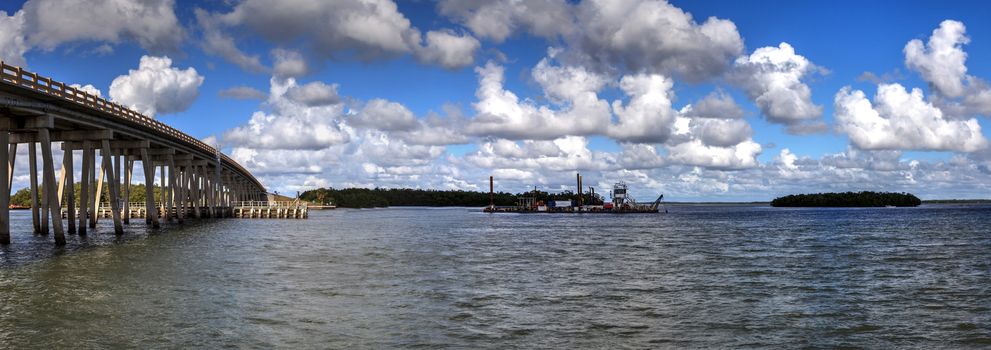 Bonita Beach, Florida, USA – November 16, 2020: The dredging of New Pass under Big Hickory Bridge in Bonita Springs so that Estero Bay has better access to the ocean.