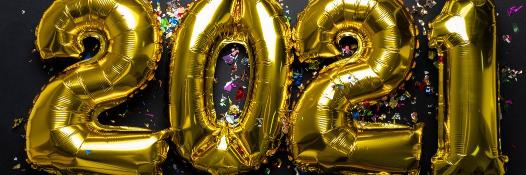 2021 concept new year numbers from golden foil balloon and confetti stock photo
