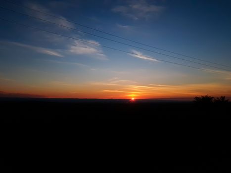 Orange sunset with clear cky. Black horizon