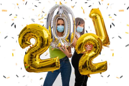 Happy friends celebrate the New Year 2021 with face masks