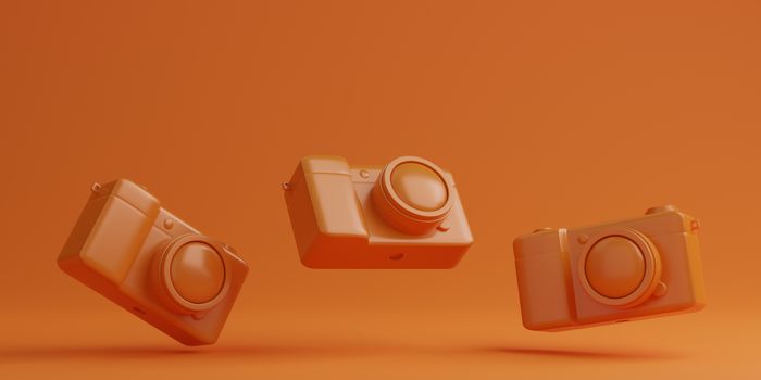 Orange digital camera on orange background, technology concept. 3d rendering