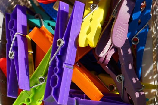 multicolored clothespins close up in sunlight.