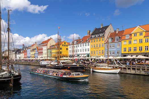 Copenhagen, Denmark - August 21, 2019: Famous Nyhavn district in the city centre with colorful houses.