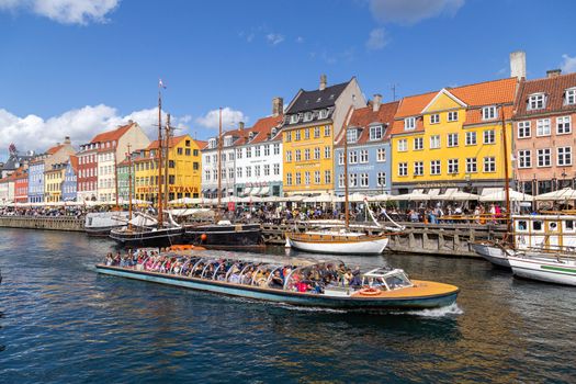 Copenhagen, Denmark - August 21, 2019: Famous Nyhavn district in the city centre with colorful houses.