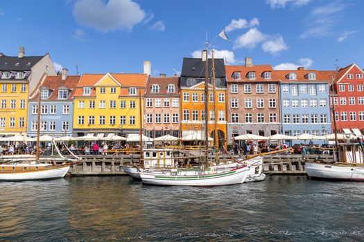 Copenhagen, Denmark - August 21, 2019: Famous Nyhavn district in the city centre with colorful houses.