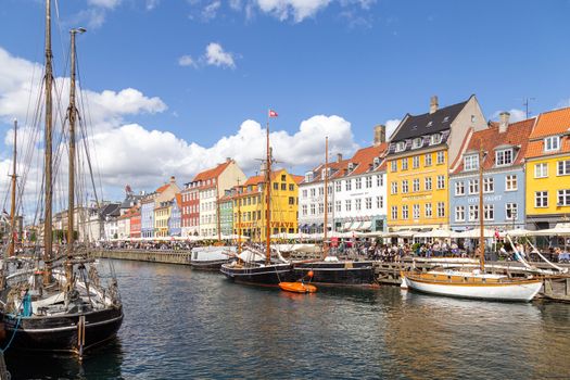 Copenhagen, Denmark - August 21, 2019: Famous Nyhavn district in the city centre with colorful houses.