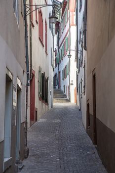 Basel, Switzerland - March 10, 2019: Old houses in an alley in the historic city centre of the swiss city Basel