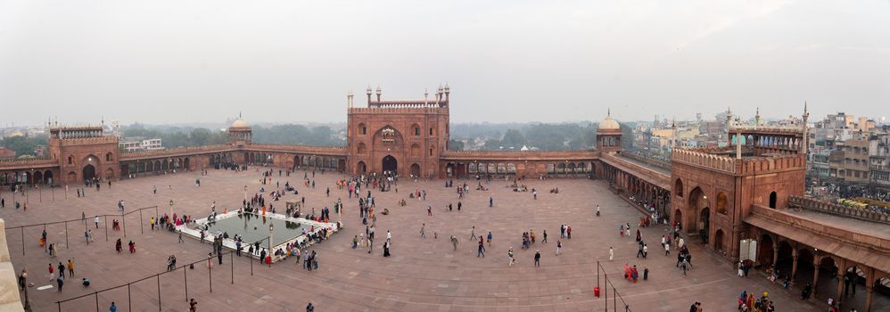 Delhi, India - December 04, 2019: The three entrance gates to Jama Masjid with people on the square.