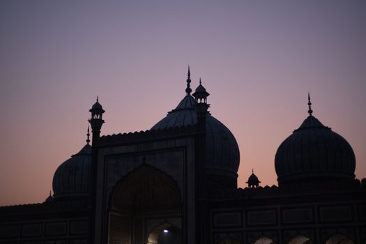 Delhi, India - December 04, 2019: Silhouette of historic Jama Masjid during sunset.