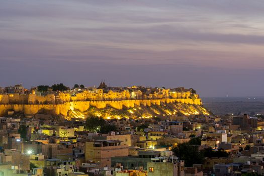 Jaisalmer, India - December 5, 2019: The illuminated Jaisalmer Fort during sunset.