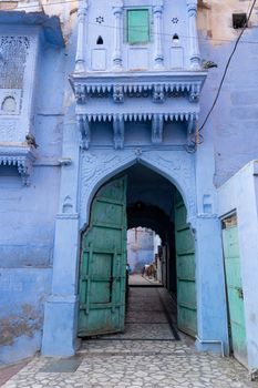 Jodhpur, India - December 9, 2019: An old door to a traditional blue house.