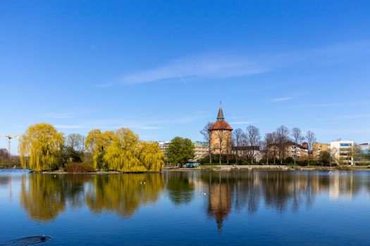 Malmo, Sweden - April 20, 2019: View over the lake in Pildammsparken with the former water tower.