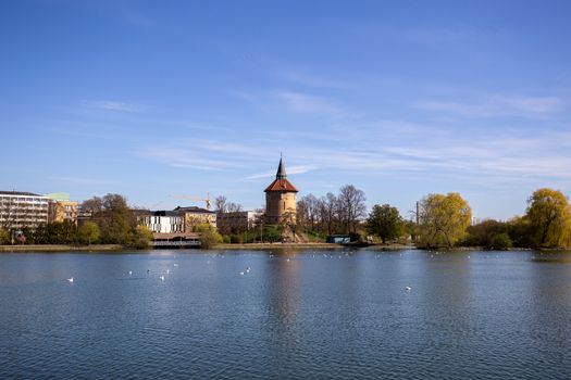 Malmo, Sweden - April 20, 2019: View over the lake in Pildammsparken with the former water tower.