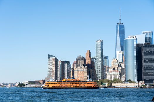 New York, United States of America - September 19, 2019: Staten Island ferry sailing in front of the Lower Manhattan skyline.