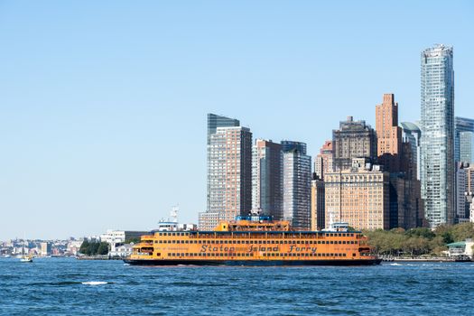 New York, United States of America - September 19, 2019: Staten Island ferry sailing in front of the Lower Manhattan skyline.