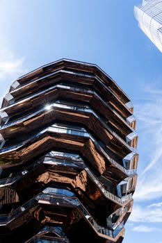 New York, United States - September 21, 2019: The Vessel, a spiral staircase landmark at Hudson Yards in Manhattan. Designed by architect Thomas Heatherwick in 2019.