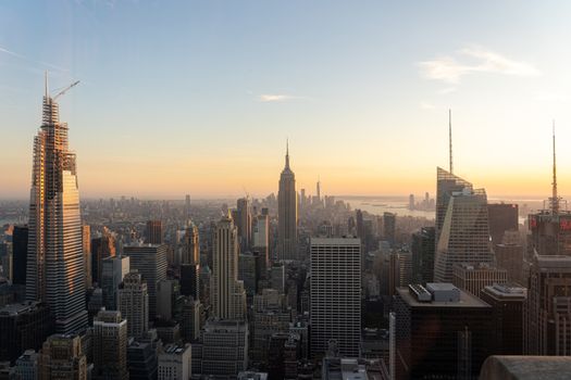 NYC, USA - September 21, 2019: NYC skyline with the Empire State Building in the foreground seen from top of the Rockefeller Center