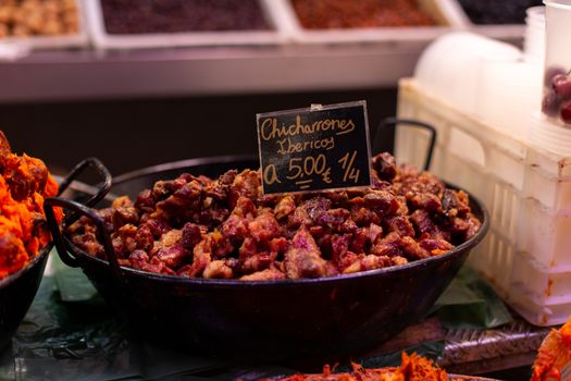 Malaga, Spain - May 24, 2019: Fried pork skin called Chicharrones for sale at the historic Atarazanas Market.