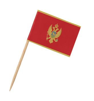 Small paper flag of Montenegro on wooden stick, isolated on white