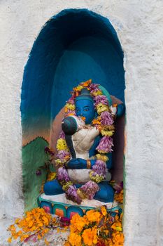 Kathmandu, Nepal - December 03, 2014: Small coloful buddhist statues at Boudhanath Stupa.