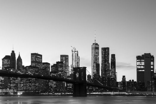 New York, United States of America - November 18, 2016: Skyline of Lower Manhattan with Brooklyn Bridge at sunset.