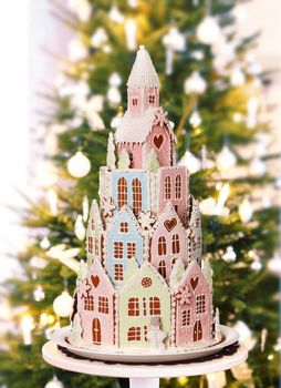 Gingerbread castle with real fir Christmas tree on home living room background