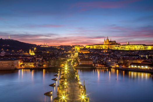 Prague, Czech Republic - March 16, 2017: Evening view of Prague Castle and Charles Bridge from the Old Town Bridge Tower