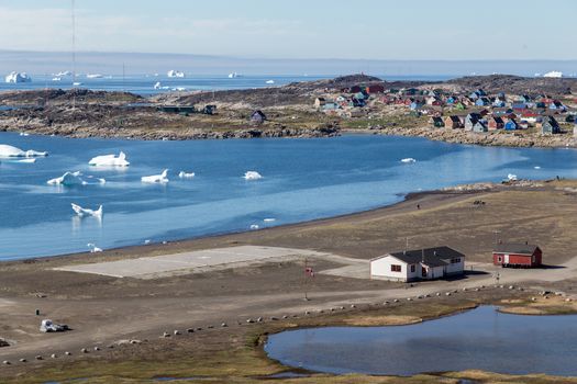 Qeqertarsuaq, Greenland - July 6, 2018: View of the heliport with the sea and the city in the background