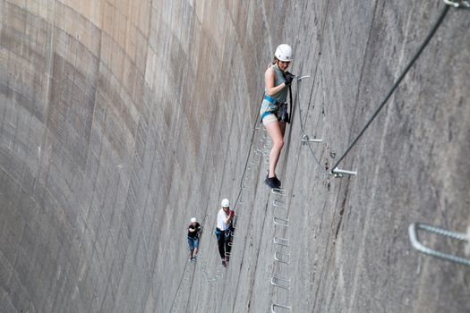 Finkenberg, Austria - June 9, 2018: Group of alpinists climbing the Via Ferrata on the Schlegeis Dam