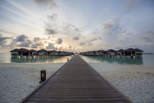 Paradise Island, Maldives - August 28, 2018: Sunrise over luxury resort villas at Paradise Island Resort on the Maldives.