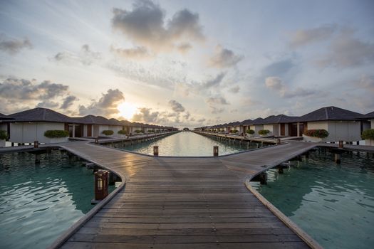 Paradise Island, Maldives - August 28, 2018: Sunrise over luxury resort villas at Paradise Island Resort on the Maldives.