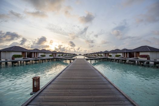 Paradise Island, Maldives - August 28, 2018: Sunrise over luxury resort villas at Paradise Island Resort on the Maldives.