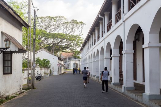 Galle Fort, Sri Lanka - July 28, 2018: People in a small cozy street in historical Galle Fort.