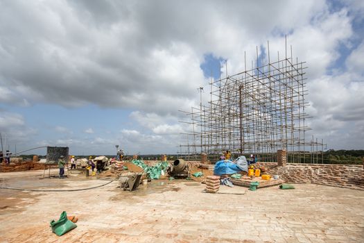 Anuradhapura, Sri Lanka - August 21, 2018: People working on top of Sandahiru Seya, the contruction sote a new stupa.